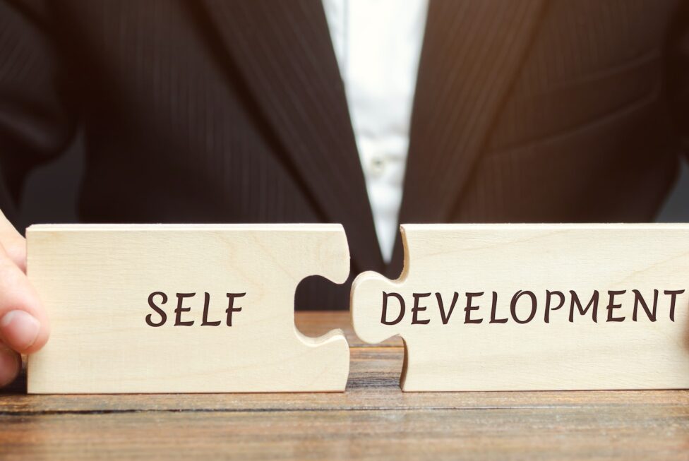 Businessman collects puzzles with the word Self-development