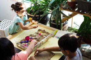 children playing kinetic sands at home