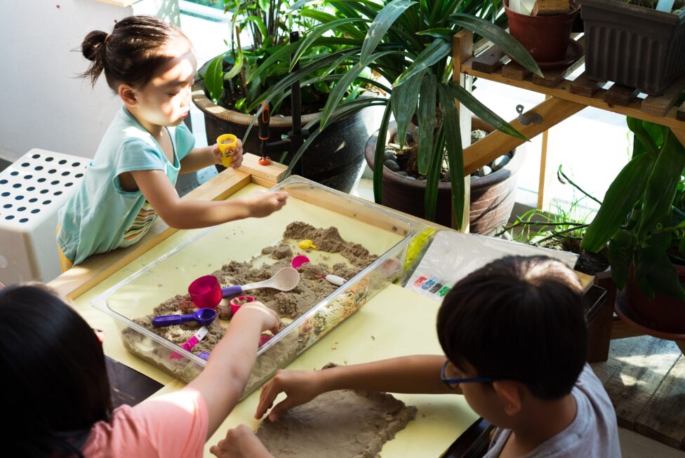children playing kinetic sands at home